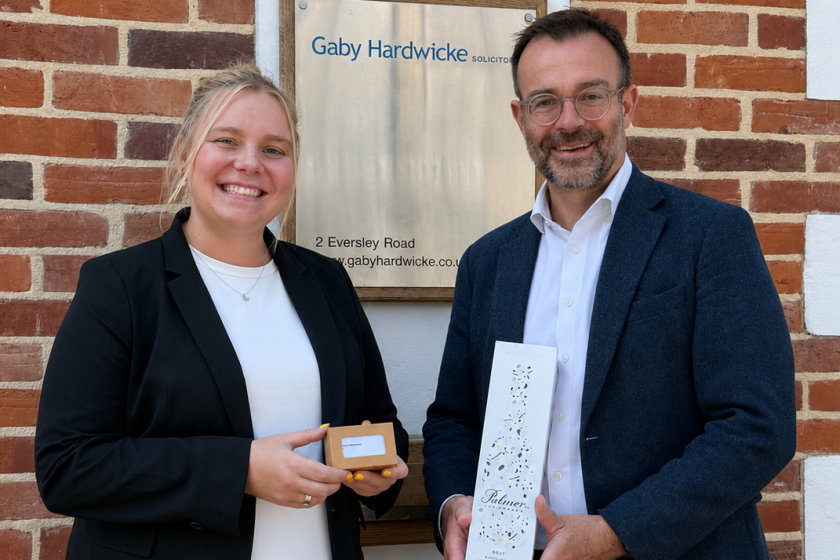 Rebecca Sweetman receiving her business cards from Jeremy Laws